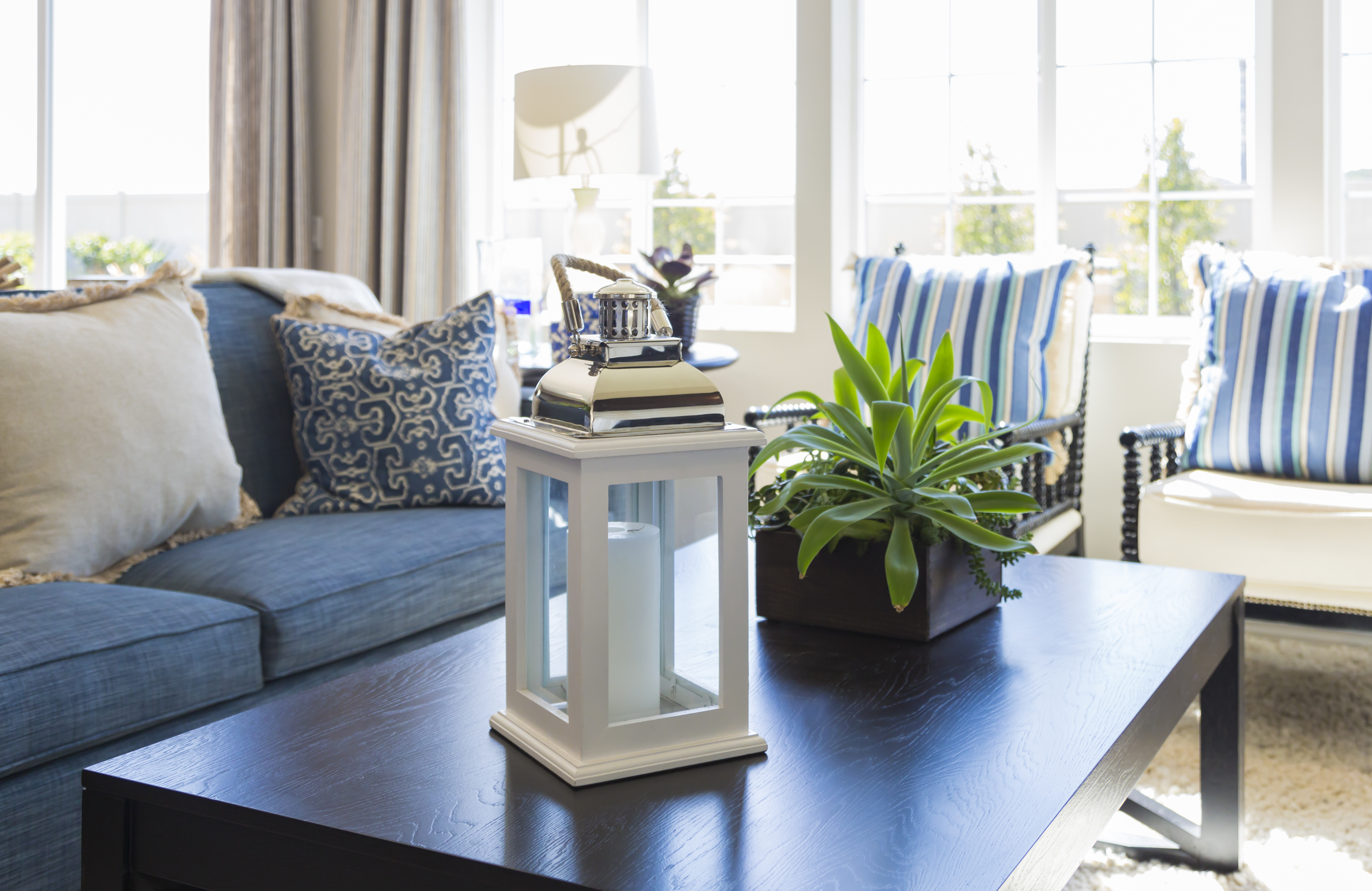 Beautiful Blue Accented Living Area with Coffee Table, Couch and Chairs of Home.